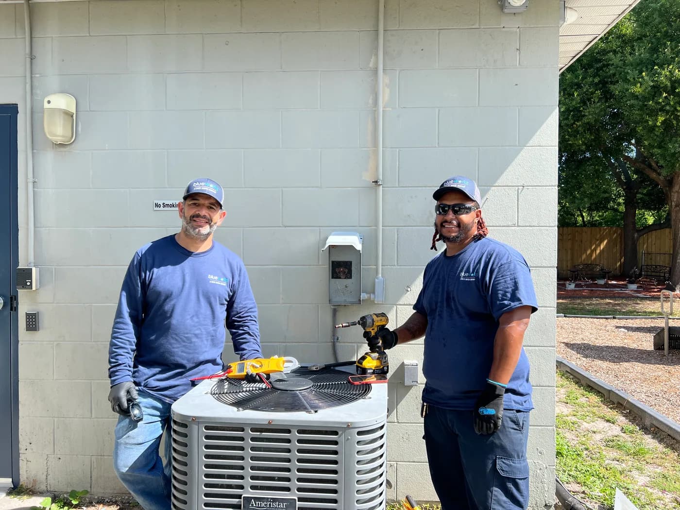 Blue Works technicians performing electrical diagnostics on commercial cooling equipment